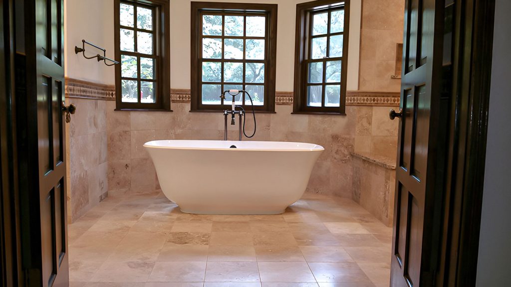 Travertine master bathroom featuring a freestanding tub.