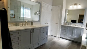 Austin bathroom vanity cabinets and walls painted in neutral gray and white tones