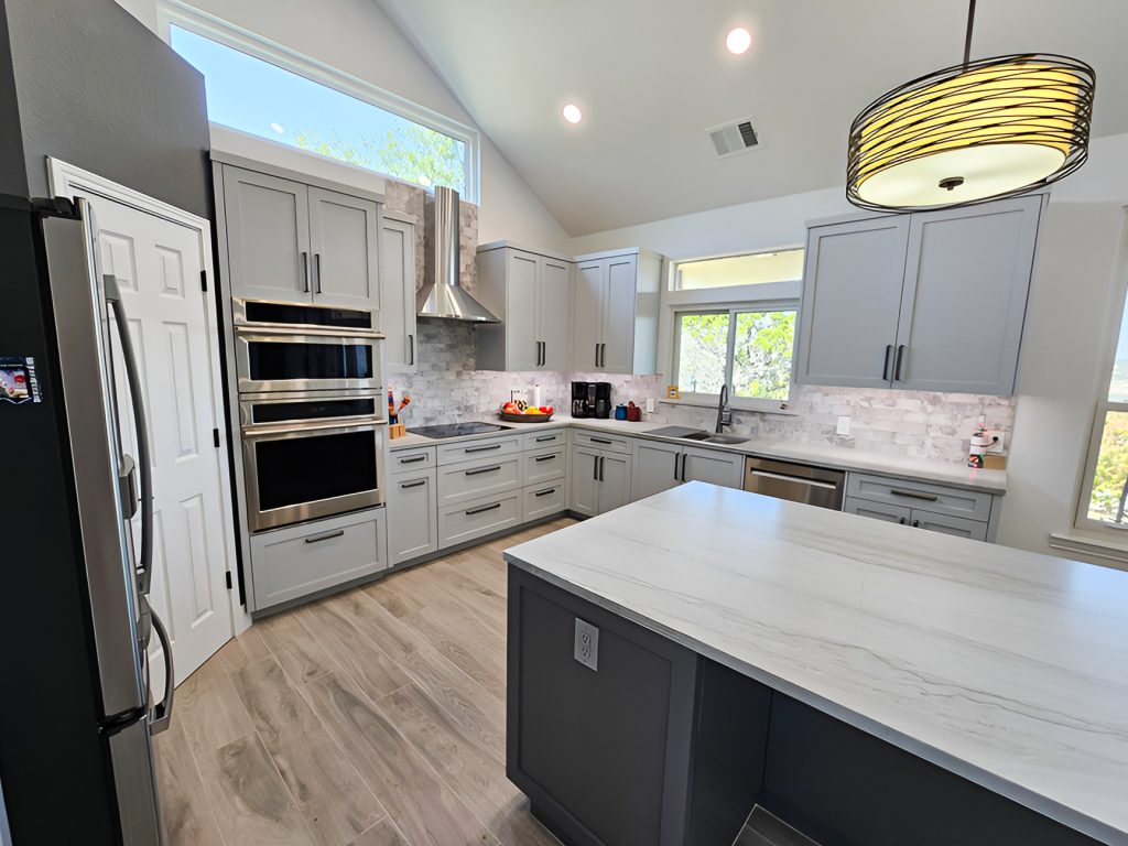 Lago Vista, TX Kitchen remodel with painted shaker style cabinets And Quartz countertops.