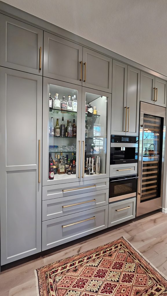 Modern Austin kitchen remodel with built-in coffee maker speed oven and wine fridge.