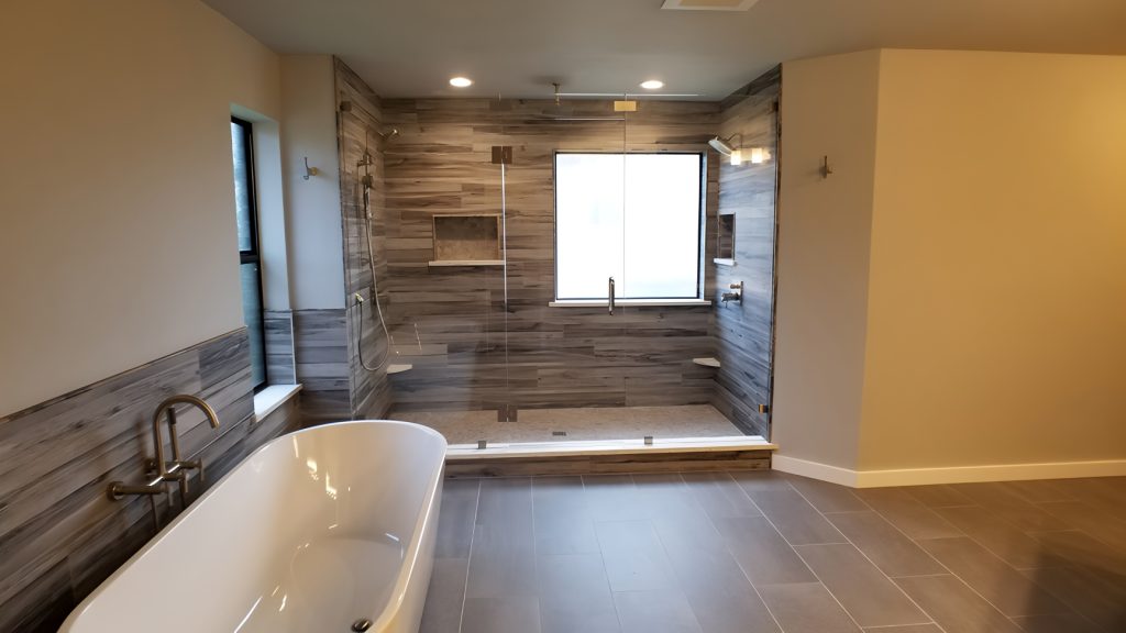 After photo of a remodeled South Austin bathroom featuring Spacious shower, updated finishes and modern design by MHM Remodeling.