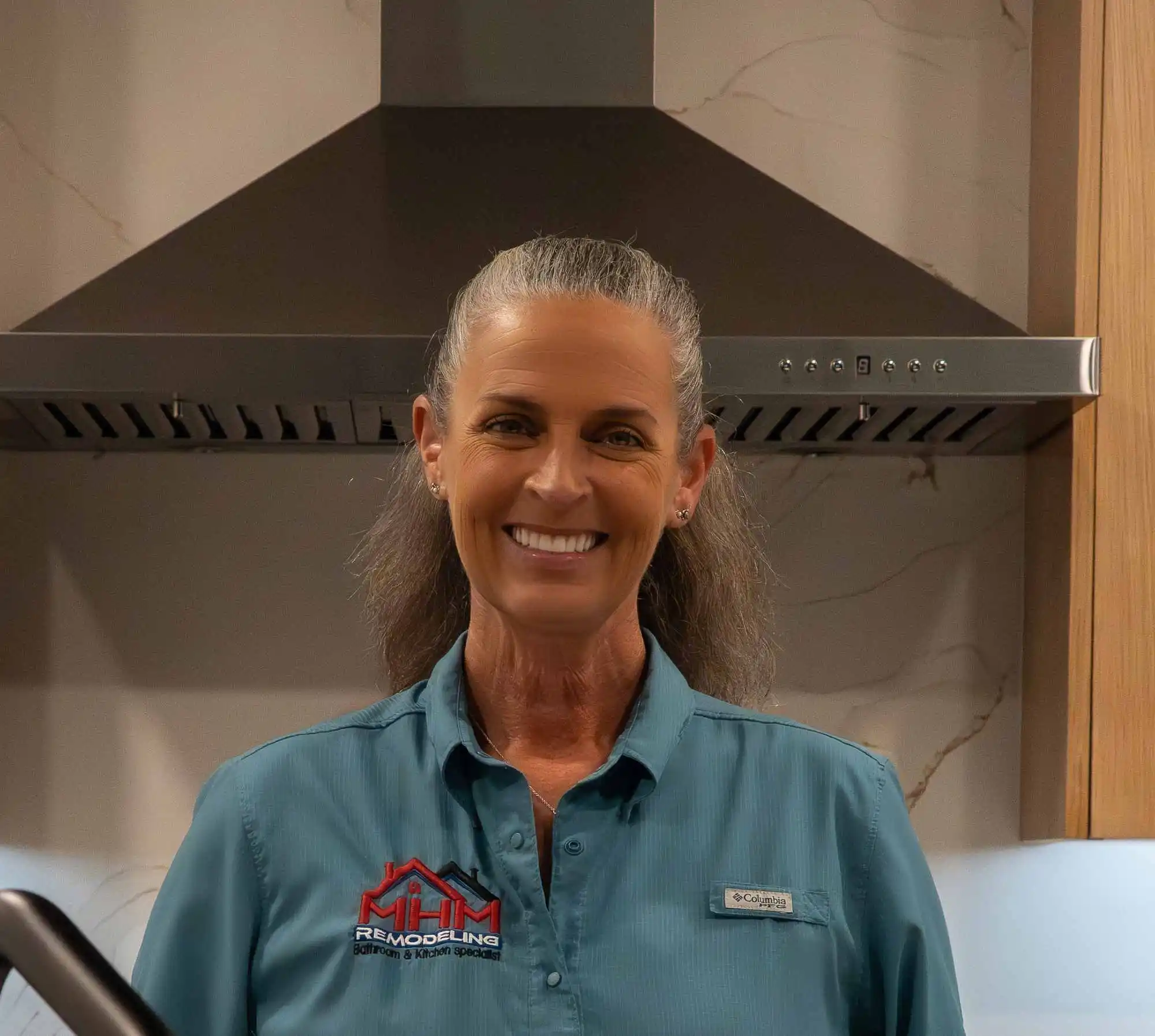 Cindy Stathos standing in the remodeled kitchen of her Jonestown, Texas home for the MHM Remodeling team bio.