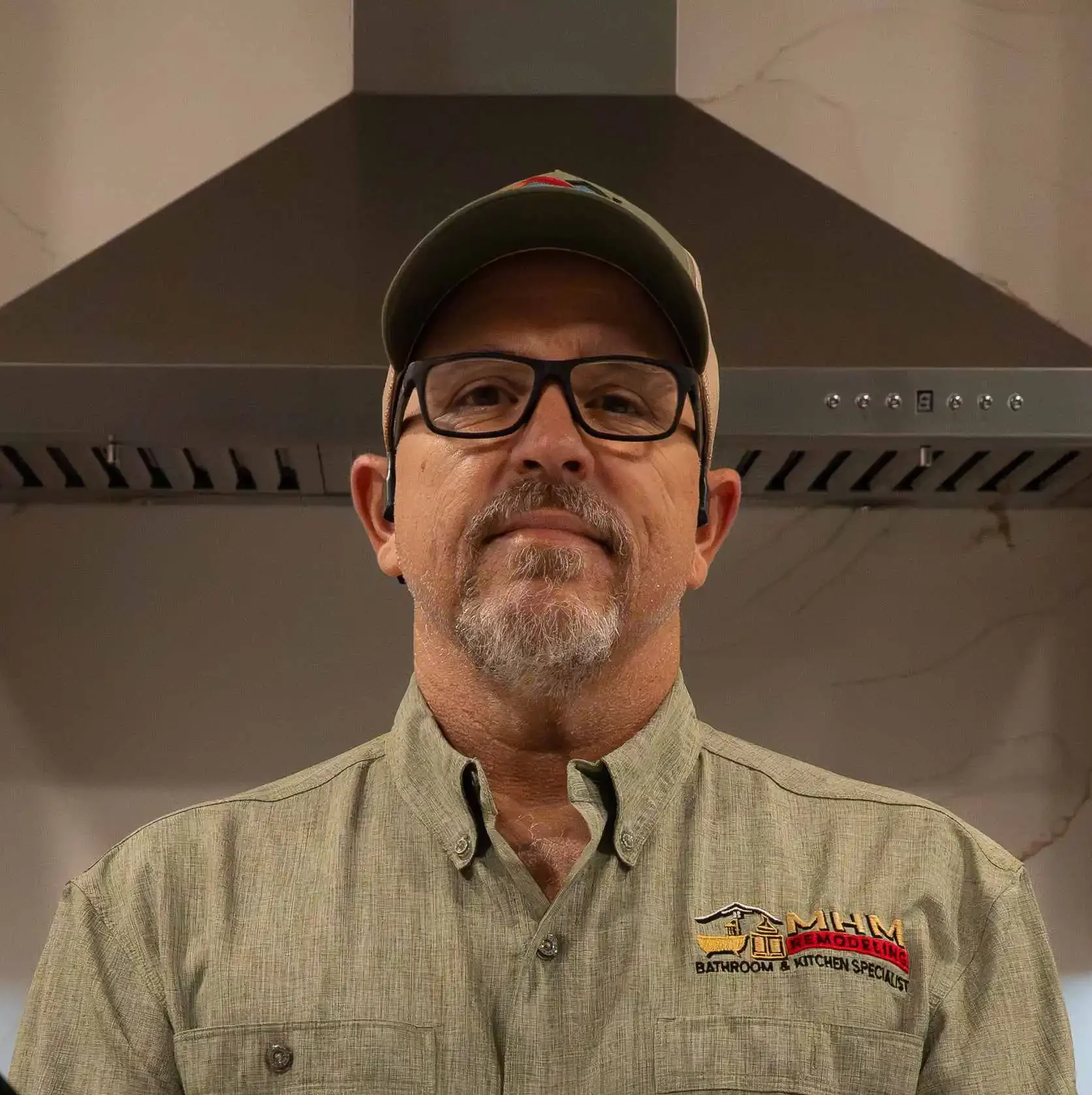 Michael Stathos standing in the remodeled kitchen of his Jonestown, Texas home for the MHM Remodeling team bio.